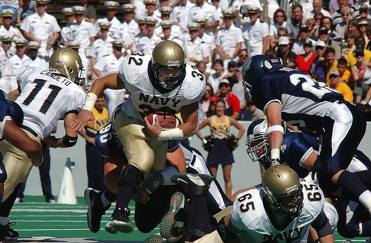 american football, football, football game, running back, ball carrier, american football field, team, competition, game, sport, football american, player, nature, football player, grass, college, pigskin, athlete, football helmet, offense, green, teamwork, athletics, helmet, action, action photo, blocking, lineman, outdoors, playing, college football, muscular, football stadium, football fans, team sport, competitive, gridiron, spectators