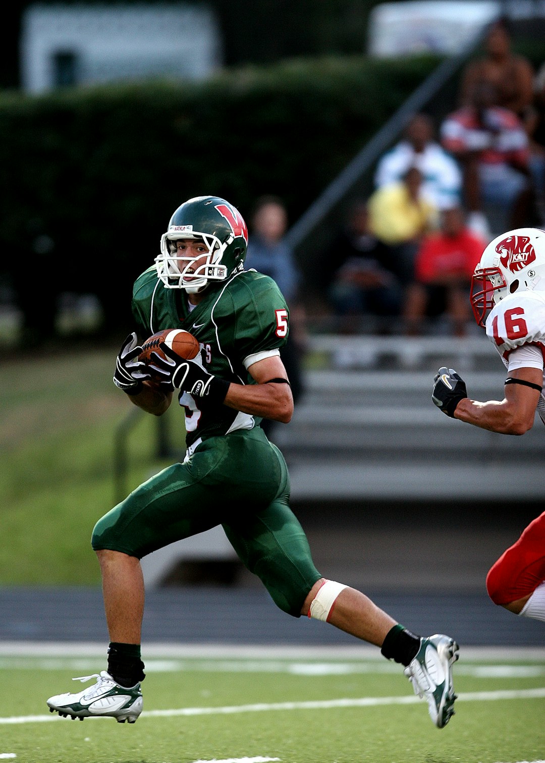 High school receiver pulls away from a defender after catching a pass in a pre-season game in Texas.